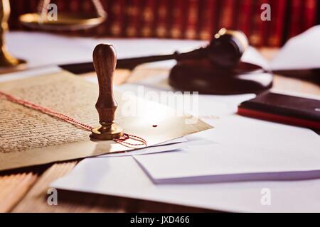 Metal wax notary public stamper on old document. Law office Stock Photo