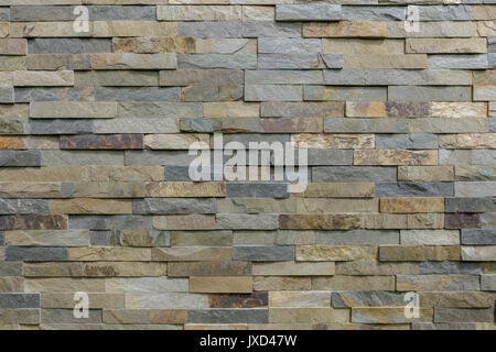 Natural stone cladding in grey, brown golden and silver colour. Stock Photo