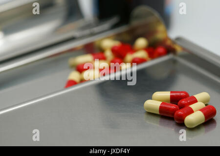 Antibiotic capsule on  stainless steel drug tray Stock Photo
