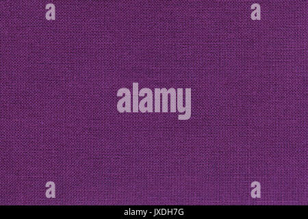 Dark violet background from a textile material with wicker pattern, closeup. Structure of the purple fabric with natural texture. Cloth backdrop. Stock Photo
