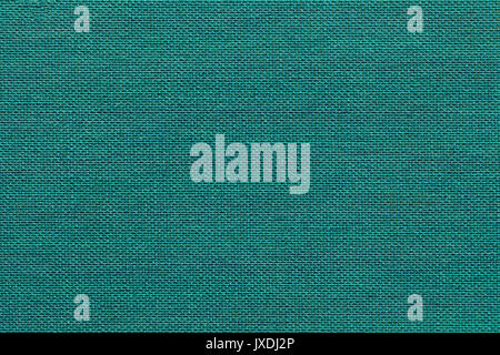Light turquoise background from a textile material with wicker pattern, closeup. Structure of the emerald fabric with natural texture. Cloth backdrop. Stock Photo
