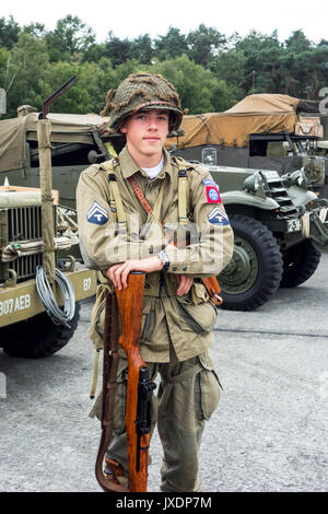 Young Re-Enactor Posing In Ww2 Us Airborne Uniform With Technician/5Th  Grade Rank Badge In Front Of American World War Two Trucks At Militaria  Fair Stock Photo - Alamy