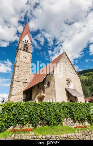 Wide-angle view of the parish church in St. Pankraz with Steeple and Haupgebäude in D'ultimo/South Tyrol in summer Anno 2017. Stock Photo