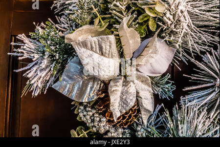 White flocked pine Chrismas wreath with white silk flower. Stock Photo