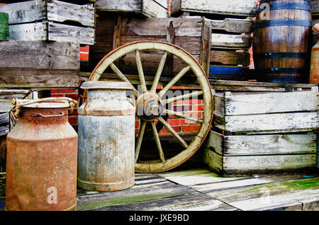 Arrangement of old stuff - Metal milk barrel, wooden boxes, fruit cases and other old stuff - Vintage Stock Photo