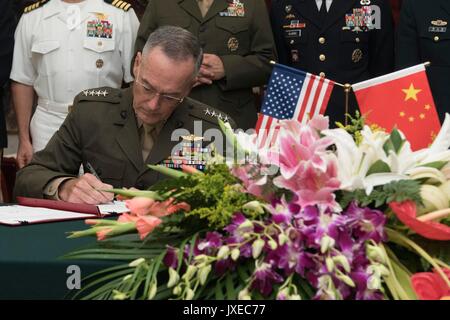 Beijing, China. 15th Aug, 2017. U.S. Chairman of the Joint Chiefs Gen. Joseph Dunford, during a signing ceremony with Chinese People's Liberation Army Gen. Fang Fenghui at the Bayi building August 15, 2017 in Beijing, China. Dunford and Fang signed an agreement to strengthen communication between the two militaries amid tensions concerning North Korea. Credit: Planetpix/Alamy Live News Stock Photo