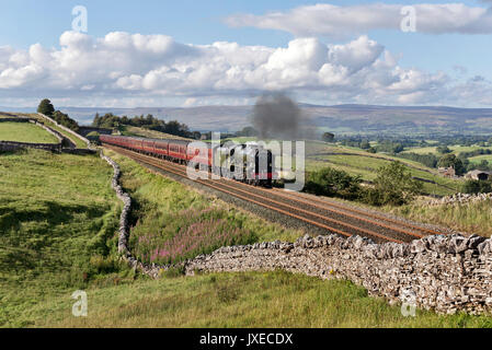 Kirkby Stephen, Cumbria, UK, 15th August 2017. Steam locomotive Scots Guardsman hauls 'The Dalesman' Summer special back from Carlisle on the Settle-Carlisle railway line, seen here at Birkett Common near Kirkby Stephen, Cumbria. Scots Guardsman is due for an overhaul and may not be seen again on the railway network for some time. Significantly the locomotive is seen with a 'Thames-Clyde Express' headboard, which was the name of one of the express train services that ran over this railway line back in the days of steam. Credit: John Bentley/Alamy Live News Stock Photo