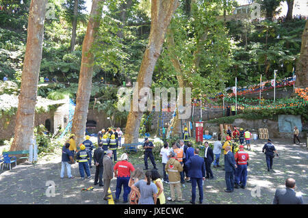 Lisbon, Portugal. 15th Aug, 2017. Rescuers work at the site where a 200-year-old oak tree collapsed during a religious procession on the Portuguese island of Madeira, Portugal, on Aug. 15, 2017. Thirteen people are now confirmed dead and dozens of others injured after a large tree collapsed on the Portuguese island of Madeira around midday Tuesday, local media reported. Credit: Helder Santos/Xinhua/Alamy Live News Stock Photo