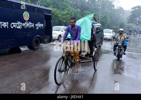 Dhaka, Bangladesh. 16th Aug, 2017.  Bangladeshi rickshaw pullers make their way with commuters during a monsoon rain in Dhaka, Bangladesh. Credit: SK Hasan Ali/Alamy Live News Stock Photo