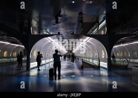 (170816) -- GUANGZHOU, Aug. 16, 2017 (Xinhua) -- Passengers walk past the cultural corridor in the Baiyun International Airport of Guangzhou, capital of south China's Guangdong Province, Aug. 16, 2017. Guangzhou Baiyun International Airport, together with the provincial museum, held a public exhibition themed on the Maritime Silk Road, the first one at the historical cultural corridor which officially opened here Wednesday. (Xinhua/Liang Xu)(wjq) Stock Photo