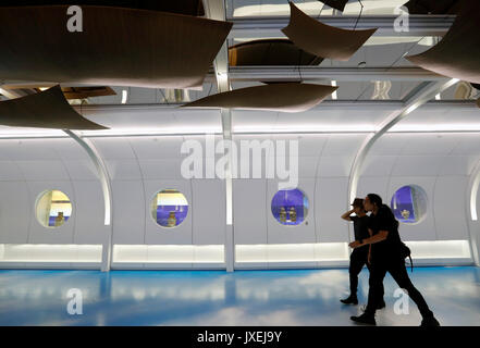 (170816) -- GUANGZHOU, Aug. 16, 2017 (Xinhua) -- Passengers walk past the cultural corridor in the Baiyun International Airport of Guangzhou, capital of south China's Guangdong Province, Aug. 16, 2017. Guangzhou Baiyun International Airport, together with the provincial museum, held a public exhibition themed on the Maritime Silk Road, the first one at the historical cultural corridor which officially opened here Wednesday. (Xinhua/Liang Xu)(wjq) Stock Photo