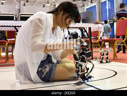 Rizhao, China's Shandong Province. 16th Aug, 2017. A contestant adjusts a robot at China robot competition in Rizhao City, east China's Shandong Province, Aug. 16, 2017. A total of 3,450 contestants from 210 universities participated in the contest. Credit: Lu Jie/Xinhua/Alamy Live News Stock Photo