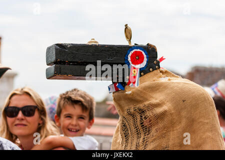 England, Broadstairs folk week. Close up of festival iconic Hooded Horse head with young boy looking and smiling at it. Stock Photo