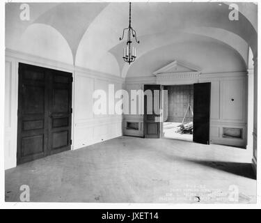 Alumni Memorial Residences Interior of the AMR, possibly of a hallway, Central to the image is a doorway leading to the woodpaneled room, A pediment is placed above the doorway, 1923. Stock Photo