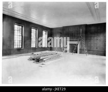 Alumni Memorial Residences Interior of AMR, Room unidentified, Room with crown molding and wood paneling appears to be finished, Several ladders lie upon the floor, 1923. Stock Photo