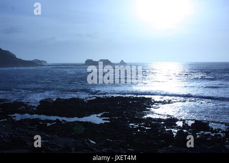 British Channel Islands. Alderney. View of coast and distant Fort Clonque in bright early evening sun. Stock Photo