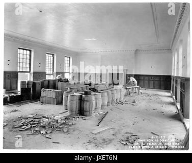 Alumni Memorial Residences Interior of the AMR, Unidentified room, Two men are doing woodwork, Room has crown molding and wood panels up to the chair rail, 1923. Stock Photo