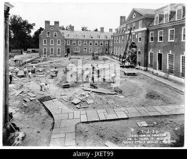 Alumni Memorial Residences Inner courtyard and main entrance to the AMR, Many men are working on laying the sidewalk to the building, 1923. Stock Photo