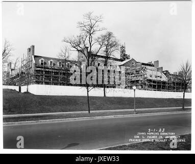 Alumni Memorial Residences View of AMR construction site from Charles Street, Glass has been placed in a few windows, City 27 Poly 0 written on construction fence, 1923. Stock Photo