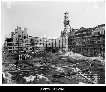 Alumni Memorial Residences AMR and courtyard under construction, Scaffolding around building, Men working on the rooftops, as well as on the ground, A lot of construction material piled in the courtyard area, 1923. Stock Photo