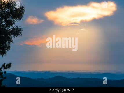 Sunset shining through a gap in the clouds over Pigeon Forge Tennessee Stock Photo