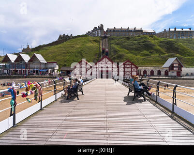 dh Saltburn pier SALTBURN BY THE SEA CLEVELAND People sitting relaxing on seaside pier summer uk Stock Photo