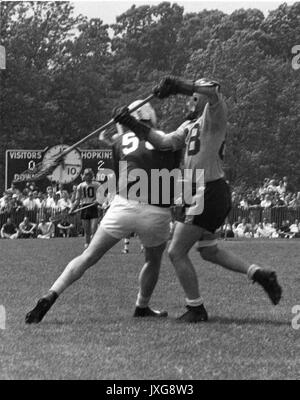 Lacrosse Action shot taken during an unidentifed match, Two players collide in an effort to catch the ball, Hopkins was winning the match 2 - 0, 1950. Stock Photo