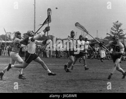 Lacrosse Action shot taken during an unidentifed match, Various players attempt to catch the ball, which is in mid-air, 1950. Stock Photo