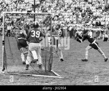 Lacrosse Action shot taken during an unidentified match, A member of the opposing team endeavors to make a goal, while Hopkins players defend the post, 1950. Stock Photo