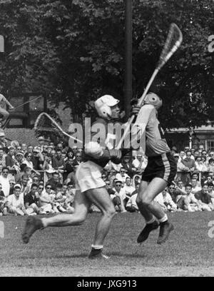 Lacrosse Action shot taken during an unidentified lacrosse match, A Hopkins player and a member of the opposing team clash over the ball, 1950. Stock Photo