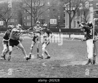 Lacrosse Action shot taken during an unidentifed lacrosse match on Homewood campus, A member of the opposing team tries to make a goal, 1950. Stock Photo