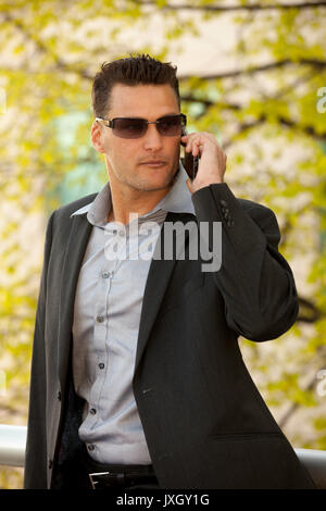Young executive  businessman with a cell or smartphone Stock Photo