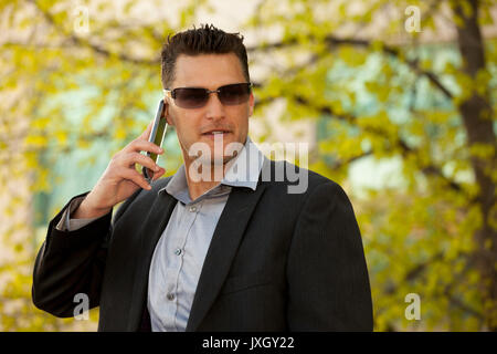 Young executive  businessman with a cell or smartphone Stock Photo