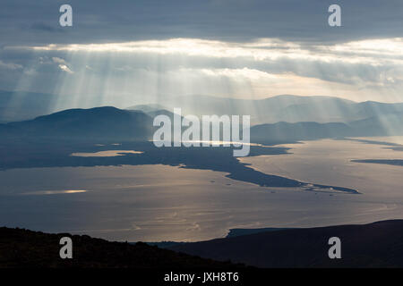 Iveragh Peninsula bathed in shafts of sunlight viewed from Slieve Mish mountains on the Dingle Peninsula in County Kerry, Ireland Stock Photo