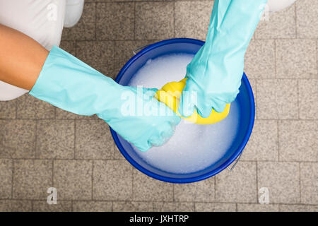 Bucket full of soap suds and hand washing Stock Photo - Alamy