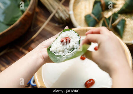 Middle-aged women are making zongzi Stock Photo