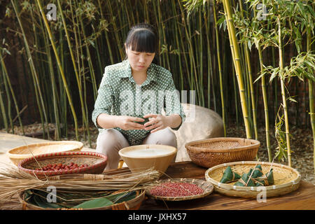 Middle-aged women are making zongzi Stock Photo