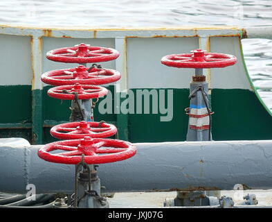 Pipes and control valves on an oil supply ship Stock Photo