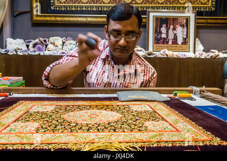 A man creating an embroidered Zardozi wall hanging , Agra India. Stock Photo