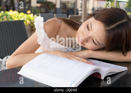 asian girl laying on book Stock Photo