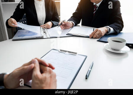 Businessman conducting an interview with businessman in an office. Stock Photo