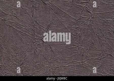Dark gray wavy background from a textile material. Fabric with fold texture closeup. Creased shiny brown cloth. Stock Photo