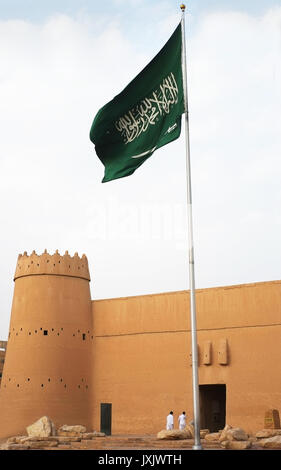 Saudi flag flies in the vicinity of heritage and historic Al Masmak Fortress in Riyadh Saudi Arabia Stock Photo
