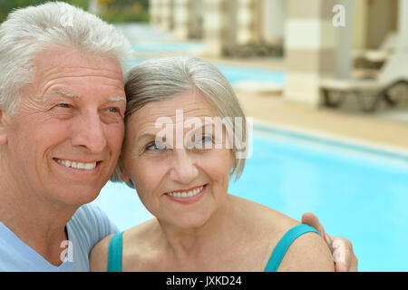 Senior couple relaxing at pool Stock Photo
