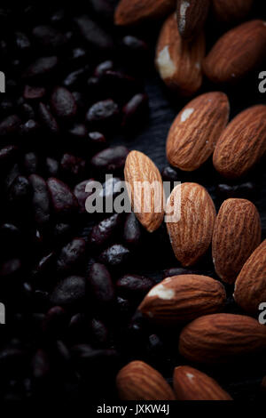 Almonds and sunflower seeds in chocolate on a dark background. Studio. Stock Photo