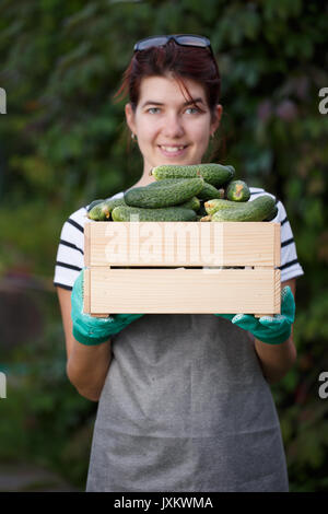 Young girl with cucumber crop Stock Photo