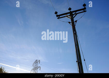 Power supply lines against a blue sky. Stock Photo