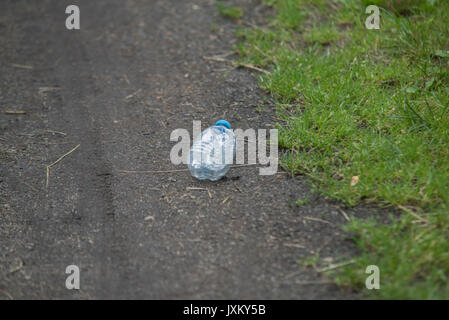 garbage on green grass in the nature environment problems Stock Photo