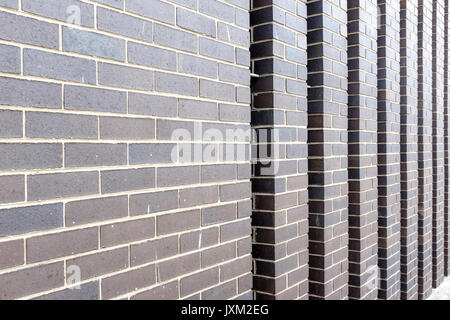 A modern brick wall with vertical inserts shot at an angle Stock Photo