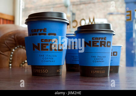 Close up of Cafe Caffe Nero disposable coffee cups cup takeout takeaway on table in shop store England UK United Kingdom GB Great Britain Stock Photo